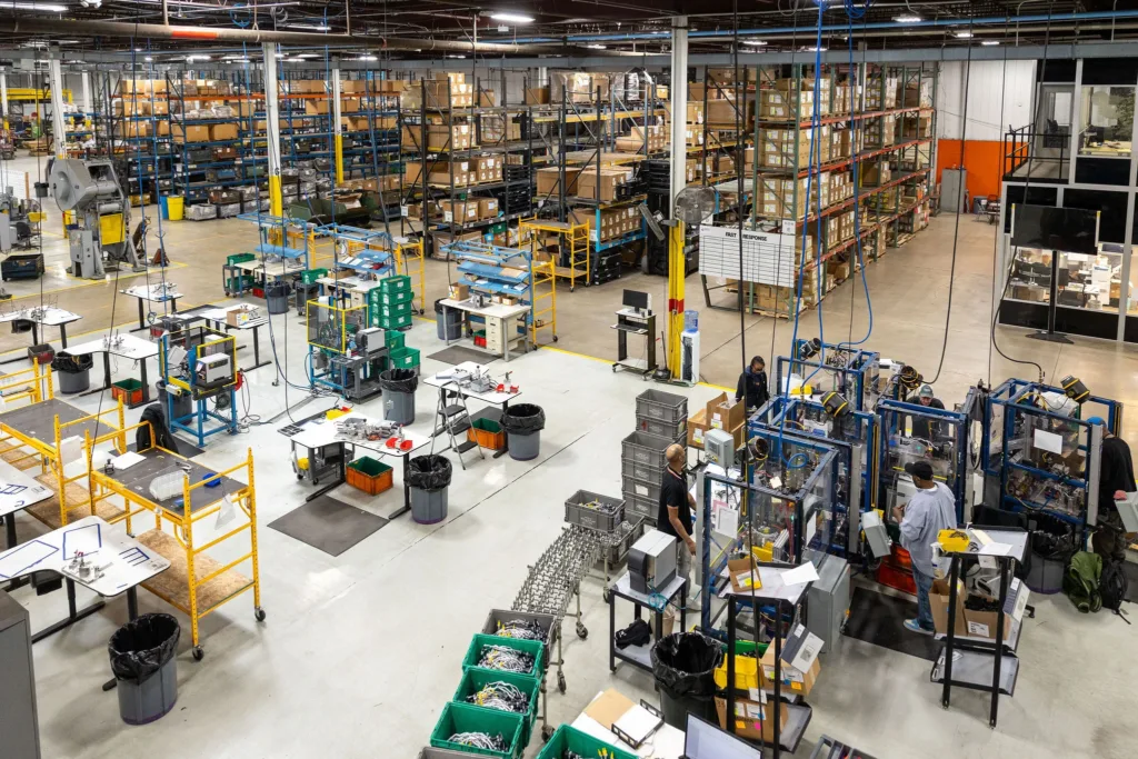 Aerial shot of GS3 shop floor including employees, machinery, shelving and boxes